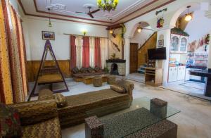 a living room with a couch and a fireplace at Ram Cottage Chail 3 BHK villa with Lawn & Parking in Chail