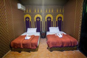 Postel nebo postele na pokoji v ubytování Palmeras Y Dunas Luxery Camp