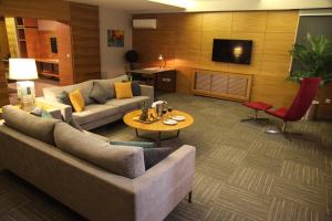 a living room with a couch and a table at Hotel Yayoba in Tekirdag