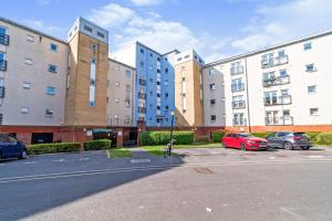 a parking lot with cars parked in front of buildings at BEST PRICE! Superb city centre apartment, 2 Superkings or 4 singles Smart TV & Sofa bed- FREE SECURE PARKING in Southampton