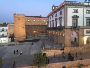a group of people walking in front of a building at KubiK APARTAMENTOS K1 in Cáceres