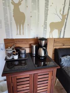 a table with a coffee maker on top of it at Erholsame 2 Zimmer FeWo mit King-Size-Bett, Pool und Stellplatz in Baiersbronn