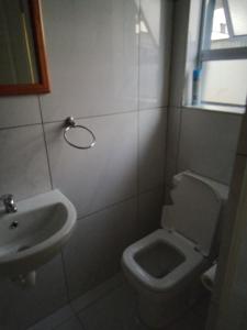 a bathroom with a toilet and a sink at 24 on WRENCH in Cape Town