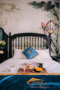 a tray of food sitting on top of a bed at Alee Haiphong Hotel in Hai Phong