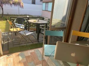 a laptop on a balcony with a table and chairs at Surf Imin G-Sun in Wakayama