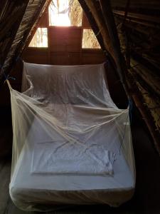 a bed is wrapped in plastic in a attic at Maria Mulata Palomino in Palomino