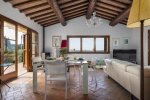 a living room with a table and a couch at Villa Montegemoli - by Bolgheri Holiday in Pomarance