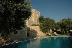 a large swimming pool in front of a building at Litiniana Villas in Triopetra