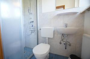 a bathroom with a toilet and a sink and a shower at Bungalow Möller in Dahme