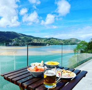 a table with food and a glass of beer at Kizkitza in Gautegiz Arteaga