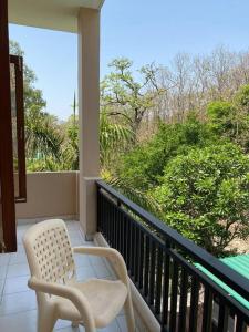 a balcony with two chairs on a porch at Nature Villa in Haldwāni