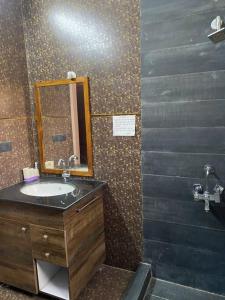 a bathroom with a sink and a mirror at Nature Villa in Haldwāni