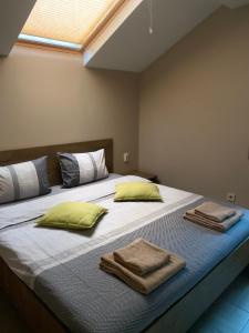 a bedroom with a large bed with towels on it at Sofia Family House - Free Parking in Sofia