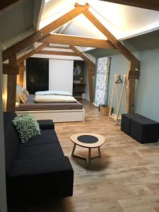 - un salon avec un canapé et une table dans l'établissement B&B Emma, à Geleen