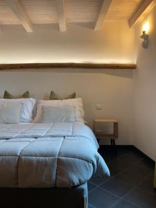 a bedroom with a blue bed with a wooden ceiling at CORTE CAIAR Bed&Breakfast in Caprino Veronese