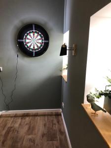 a room with a dart board on the wall at B&B Emma in Geleen