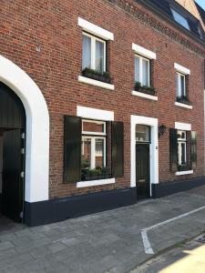 a red brick building with windows and doors at B&B Emma in Geleen
