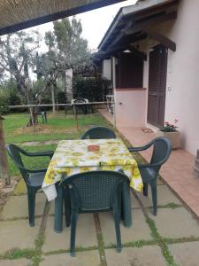 a table and chairs with a tablecloth on a patio at Girasole in Spergolaia