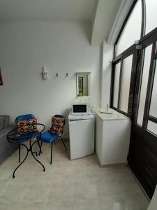 a kitchen with two chairs and a table and a stove at Casa das Netas in Lagos