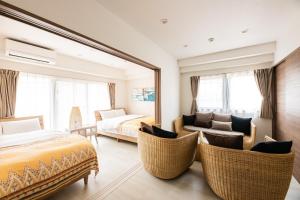 a bedroom with a bed and a couch and a mirror at Tomariehotel & condominium in Fukuoka