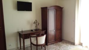 a room with a desk and a cabinet and a chair at B&B Capo Sant'Alessio in SantʼAlessio Siculo +9 photos