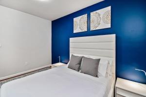 a bedroom with a white bed and blue walls at The blue wall 2BD apartment with excellent location in Philadelphia