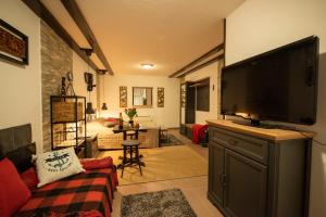 a living room with a large flat screen tv at Pleasant Apartments in Bled