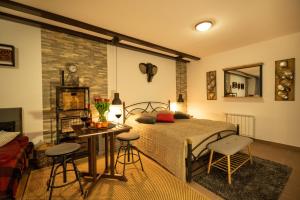 a bedroom with a bed and a table and chairs at Pleasant Apartments in Bled