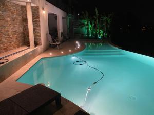 a swimming pool lit up at night at Villa l'Olivier in Cagnes-sur-Mer