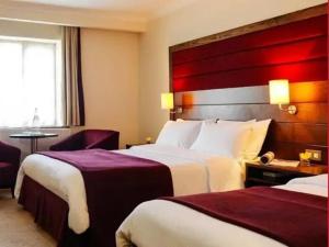 um quarto de hotel com duas camas e uma cabeceira vermelha em Town View Hotel no Cairo
