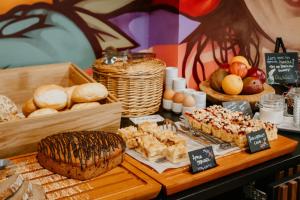 a wooden table topped with lots of different types of pastries at Rioca Vienna Posto 2 in Vienna