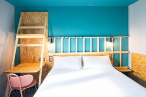 a bedroom with a bed and a bunk bed with a ladder at Birgit Hôtel Le Havre Centre in Le Havre