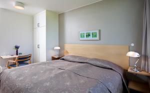 1 dormitorio con 1 cama, escritorio y mesa sidx sidx sidx sidx en The Highland Center Hrauneyjar, en Sprengisandur