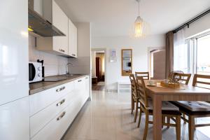 a kitchen and dining room with a table and chairs at Apartments Maja and Sanja in Baška