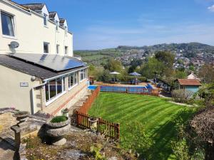 a house with a large lawn in front of it at St Andrews House B&B in Lyme Regis