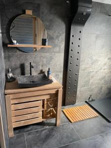 a bathroom with a sink and a mirror at Le GENKI japonais 4 étoiles in Saint-Cyr-sur-le-Rhône