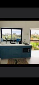 a kitchen with a sink and a window at בלקוני לחוף דור in Dor