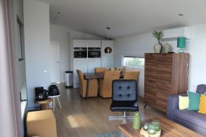 a living room with a couch and a dining room at Ravenbosch 5 ppl in Bemelen