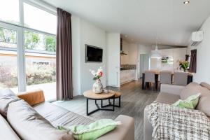 a living room with a couch and a table at Ravenbosch Sauna in Bemelen