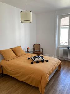 a bedroom with a bed with a stuffed animal on it at Appartement Villa Medreville in Nancy