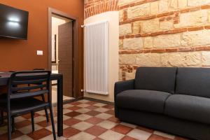 a living room with a couch and a table at ROMA PREMIUM by IDEA MONFERRATO sas in Casale Monferrato