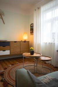 a living room with a table and a couch at Pils Parka Apartamenti in Kuldīga