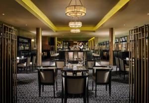 a restaurant with tables and chairs and a bar at Maryborough Hotel & Spa in Cork