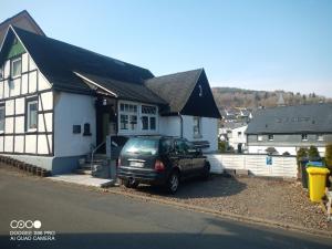 a car parked in front of a house at Sauerland Holiday House in Olsberg