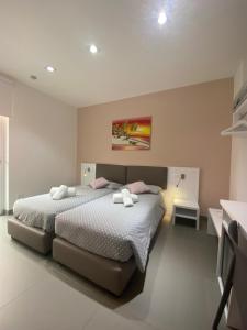 Voodi või voodid majutusasutuse Hotel Aurora & Appartamenti toas