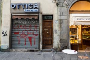 a building with a door with graffiti on it at Blue Santa Croce in Florence
