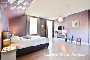Voodi või voodid majutusasutuse Hôtel l'Ecrin d'Ô toas