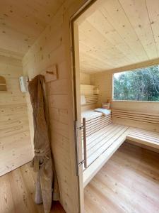 a wooden interior of a sauna with a window at Villa Angelica in Riva del Garda