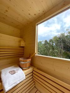a room of a wooden sauna with a window at Villa Angelica in Riva del Garda