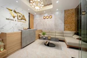 a lobby of a hotel with a couch and a table at Hummer Hotel & Apartment Da Nang Beach in Da Nang +34 photos